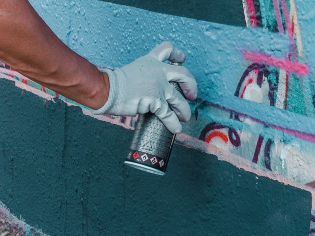 Graffiti artist painting with Montana Black spray paint