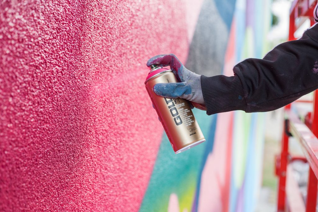 Montana Gold spray paint being used by a graffiti artist