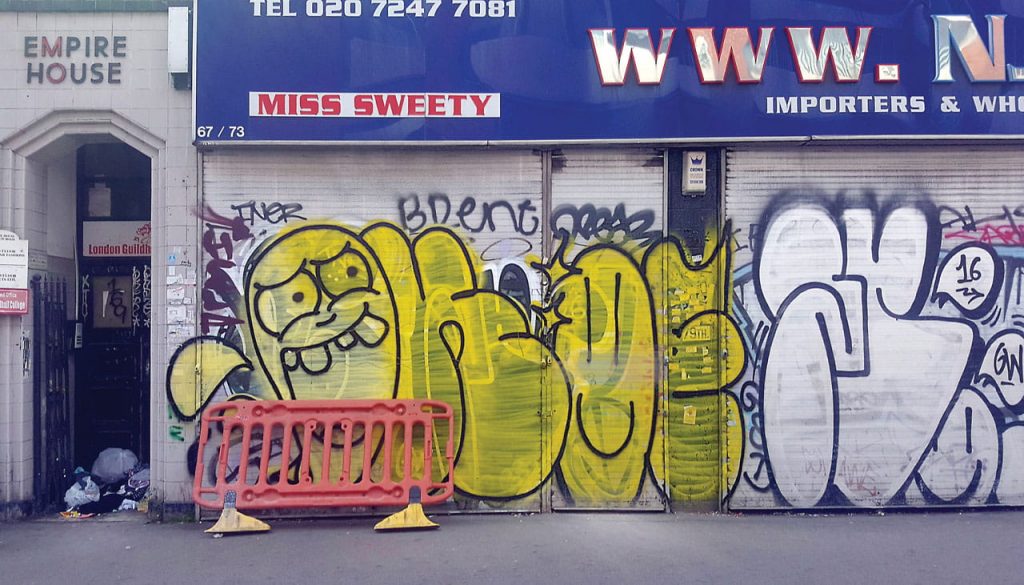 yellow and black graffiti by okey and ofske in london